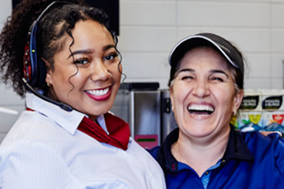 2 McDonald's staff members smiling together