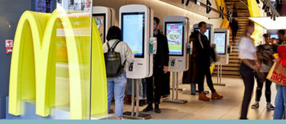 Photograph of McDonald's restaurant with self service screens. 