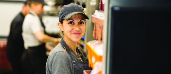 A McDonald’s Crew Member working in the kitchen