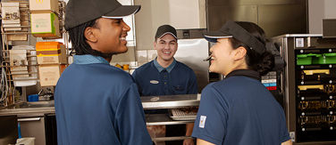 McDonald's staff serving food over the counter