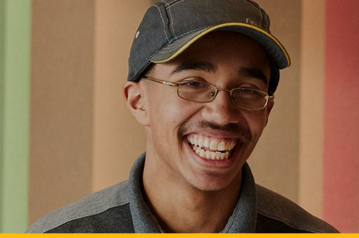 A McDonald's restaurant worker smiling. 