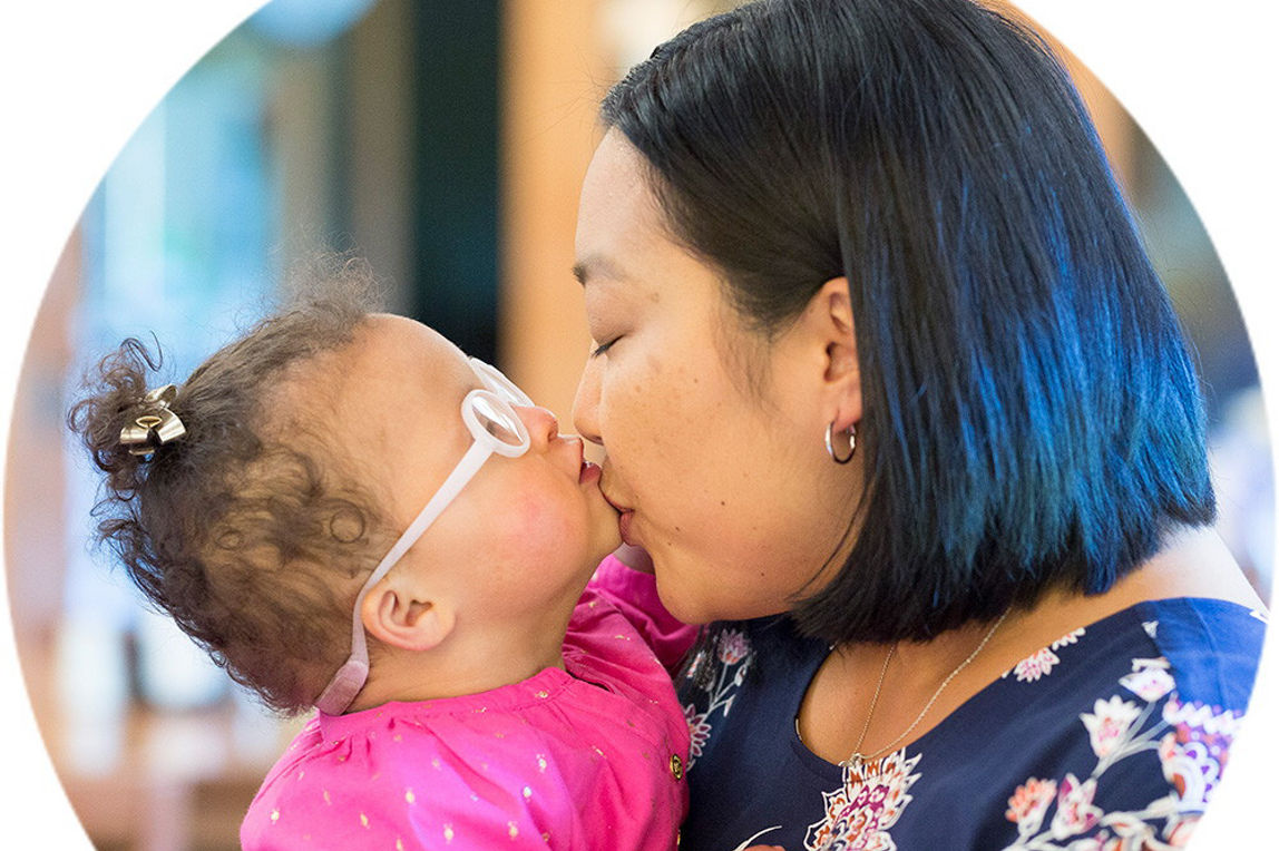 A woman kissing a child