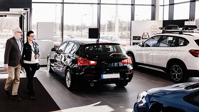 People walking into a foreign dealership