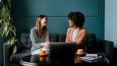 Two women having a casual meeting in an office