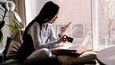 Woman purchasing something on her computer 