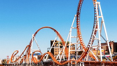 Orange metal rollercoaster at a theme park
