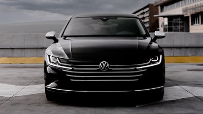 Black VW car on top of a parking garage