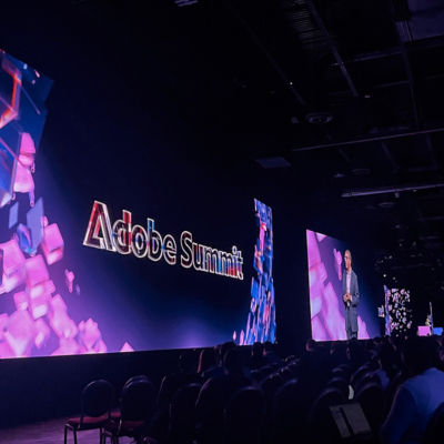 Large screen with Adobe Summit across it