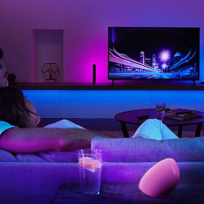 A couple lounges on the couch watching TV