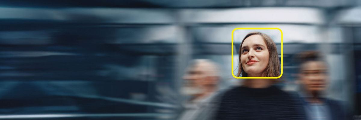 woman-in-focus-looking-up-in-front-of-blurred-background-yellow-square