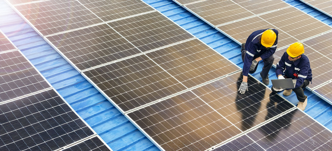 Professional inspecting solar panel installations on a rooftop ensuring renewable energy efficiency and sustainability practices highlighting clean energy technologies and environmental benefits.