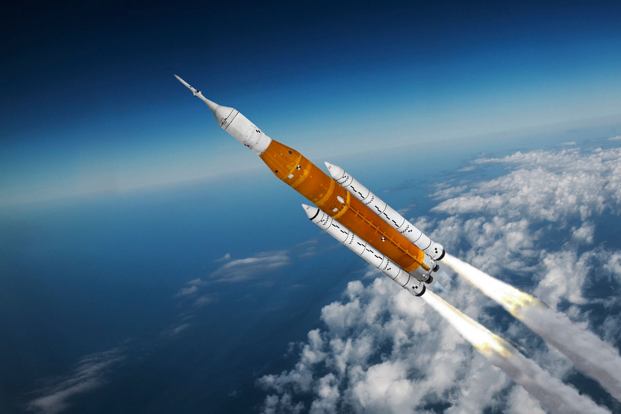 NASA Artemis Moon Program: The Space Launch System (SLS) rocket with Orion spacecraft during launch. The Artemis Program is designed to return humans to the moon.   
Where: Studio/Chino Hills. CA USA
Who/What- I created a 3D model and added detail markings plus, engine/exhaust effects. Added my own original background aerial photo with PhotoShop.