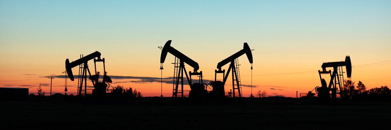 Four pump jacks producing oil, Image taken near the town of Virden, Manitoba. Image taken from a tripod.