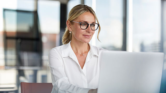 woman looking at laptop in modern office