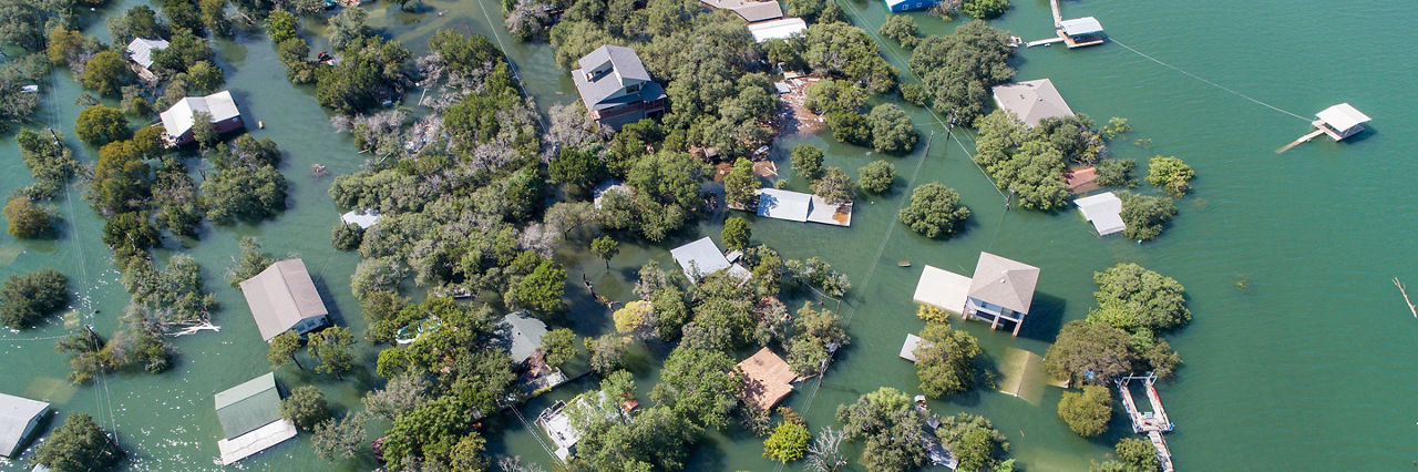 Historic Flooding in Central Texas Homes under water at Graveyard Point neighborhood community in the flood plain of Lake Travis , Aerial drone view entire Neighborhood under water near Austin , Texas