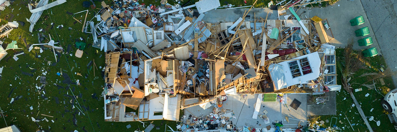 Consequences of natural disaster in southern Florida after hurricane season. Severely damaged houses in mobile home residential area.