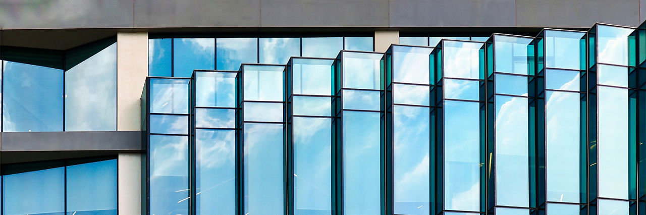 generic and minimal view of windows with sky reflection of a modern design building