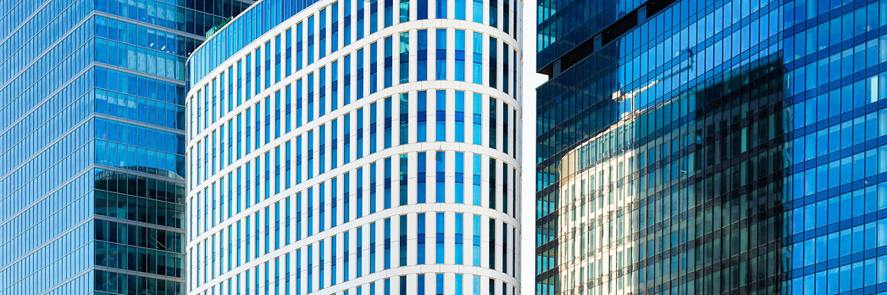 High office buildings in the business center of the city. Glass and steel. Skyscrapers as a backdrop.
