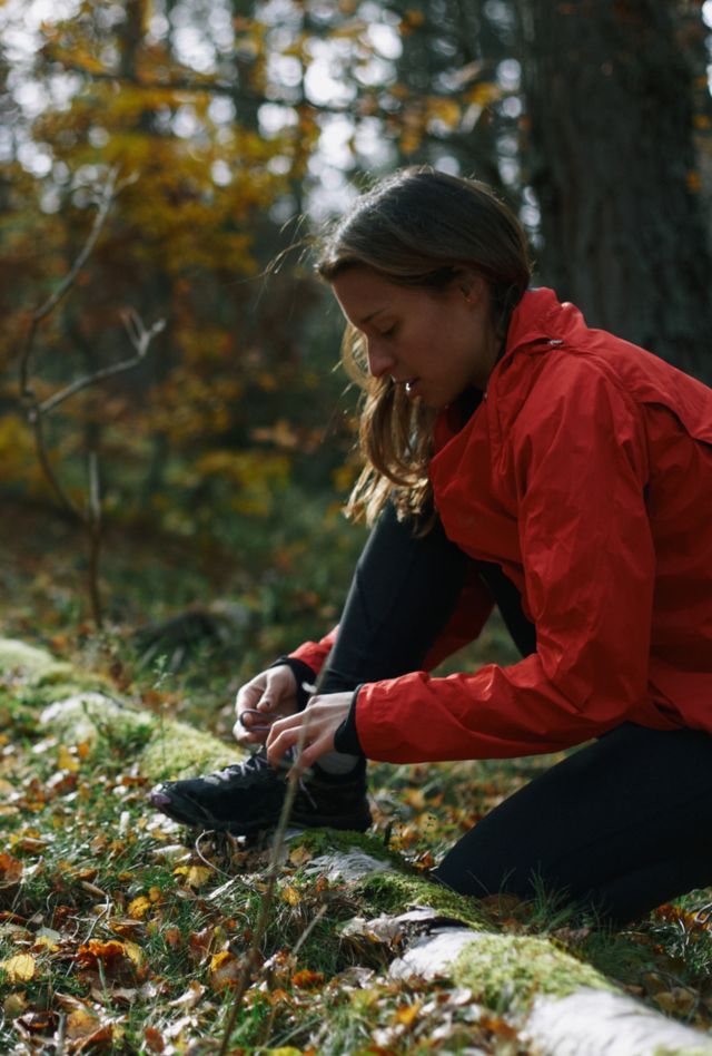 Runner Tying their Shoe Outdoors In The Forest