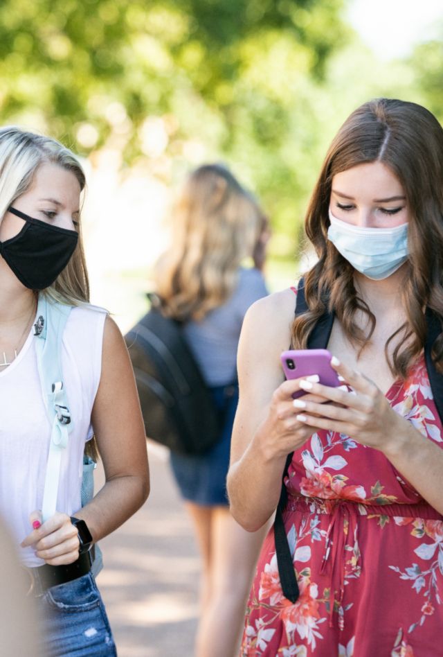 High school or college students on campus, wearing face masks during the Covid / Coronavirus pandemic.