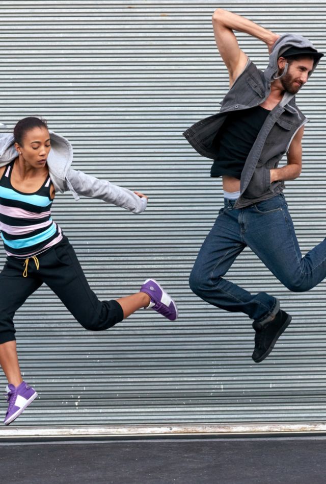 Jumping dancers on the street performing hip hop routine