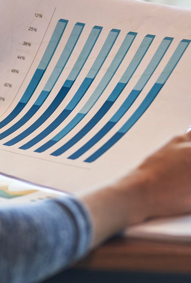 Close-up of businesswoman reading documents while working in office