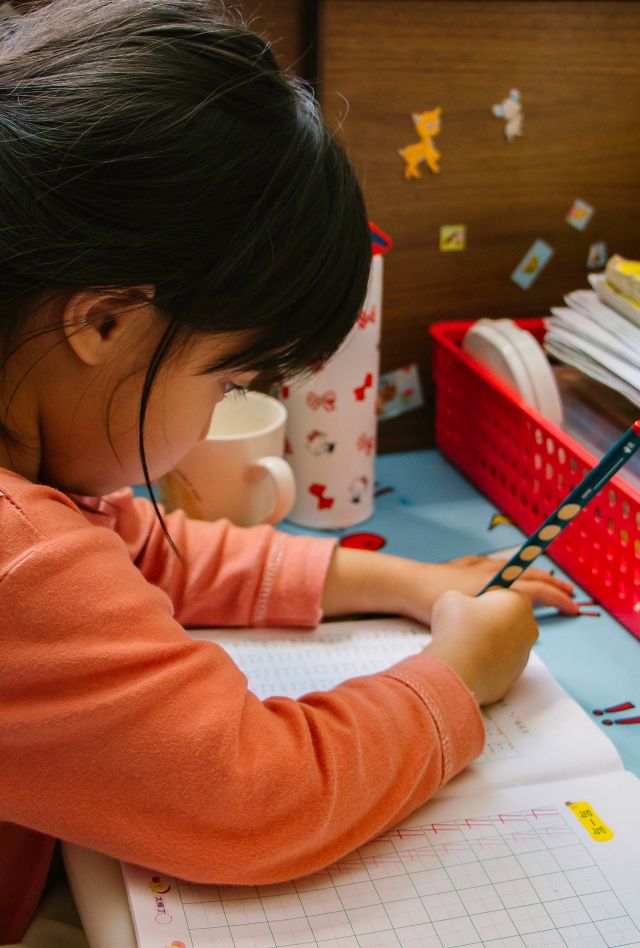 Young child writing in notebook