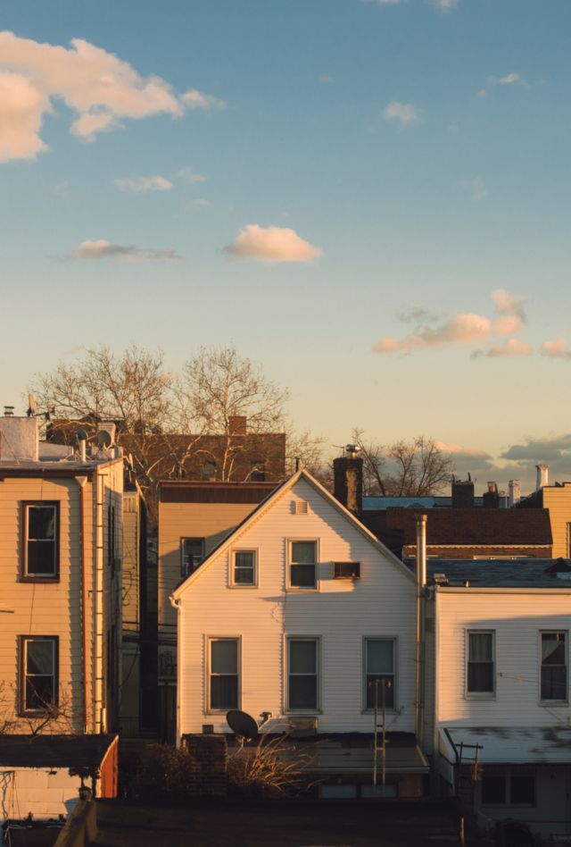 A back view of houses (wooden residential buildings, walkups) in a suburban neighborhood of the city