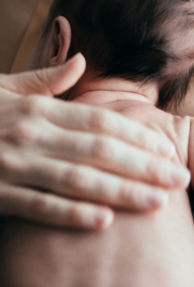 Mother cradles her 1-month old baby in her arms