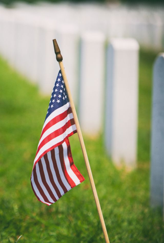 Series to commemorate Memorial Day in the United States.  Flags on headstones in a military cemetary.