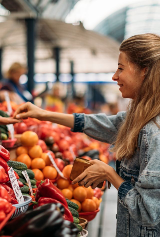 Woman buying fruits and vegetables on the market, Minks, Belarus.