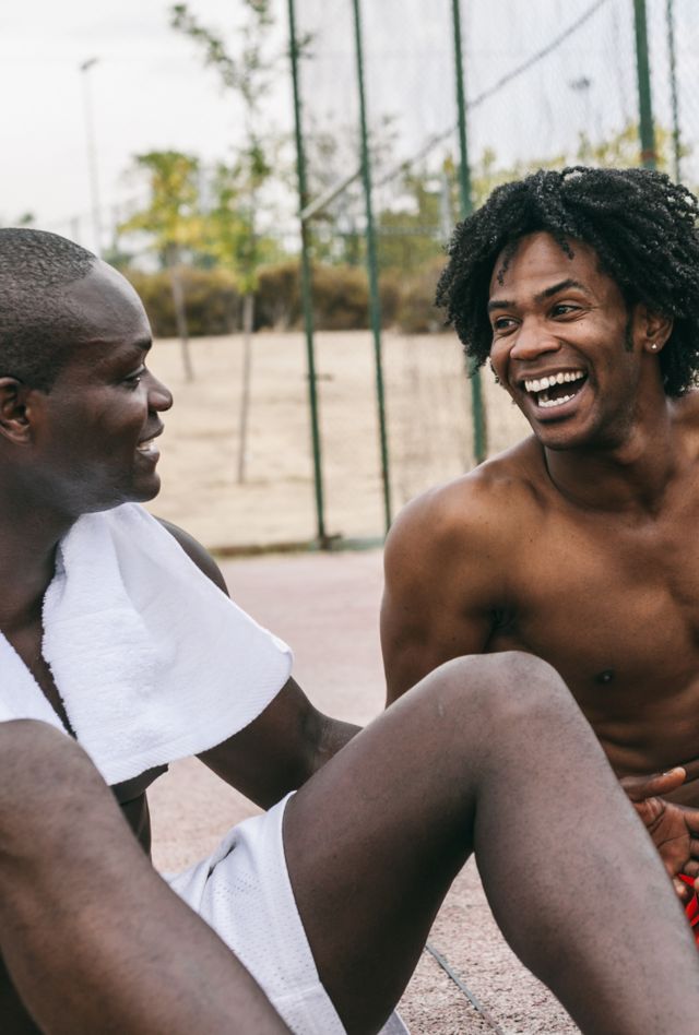 Two Black Friends Having Fun in a Basketball Street Court