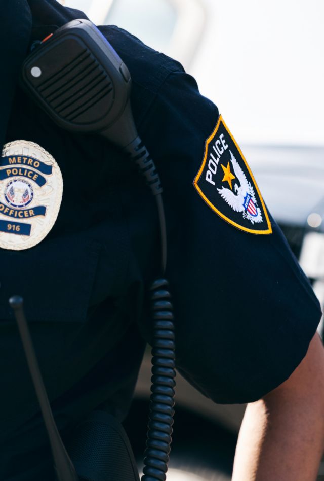 Combination video and stills series of police officers and a patrol car in a neighborhood.