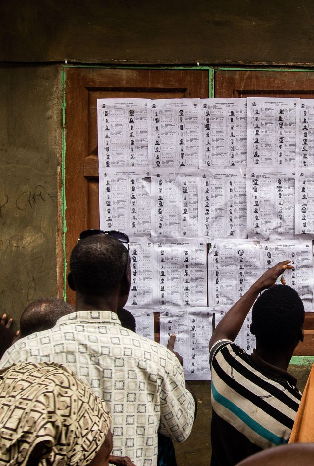 Voters check their names outside of a polling station