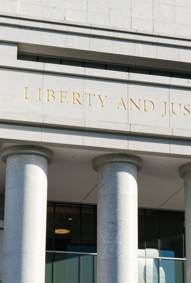 Liberty and Justice for All carved above the entrance to a building