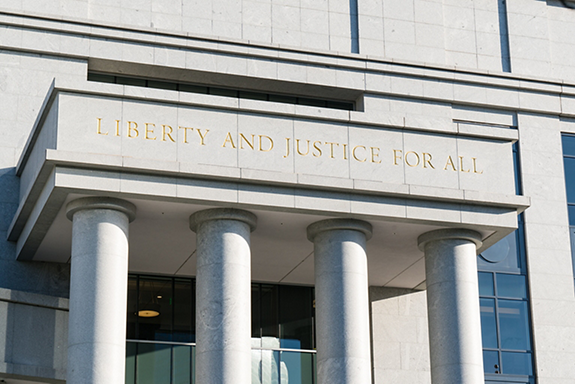 DENVER, CO - JUNE 21, 2018: Liberty and Justice for All Sign above the entrance to the Colorado State Public Defender Office in Denver