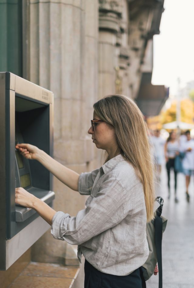 Woman taking money from bank