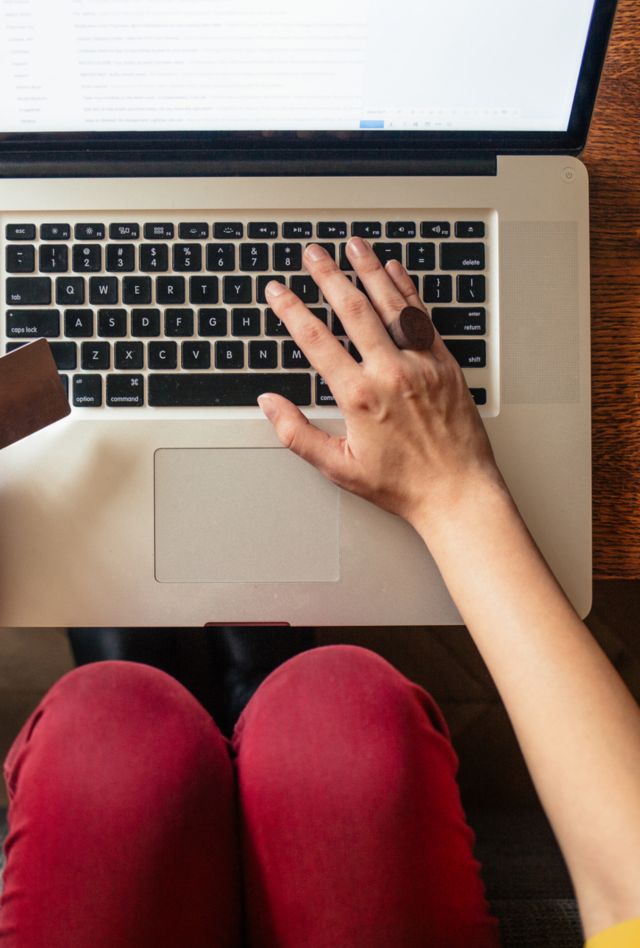 Close-up of a woman shopping online on her laptop.