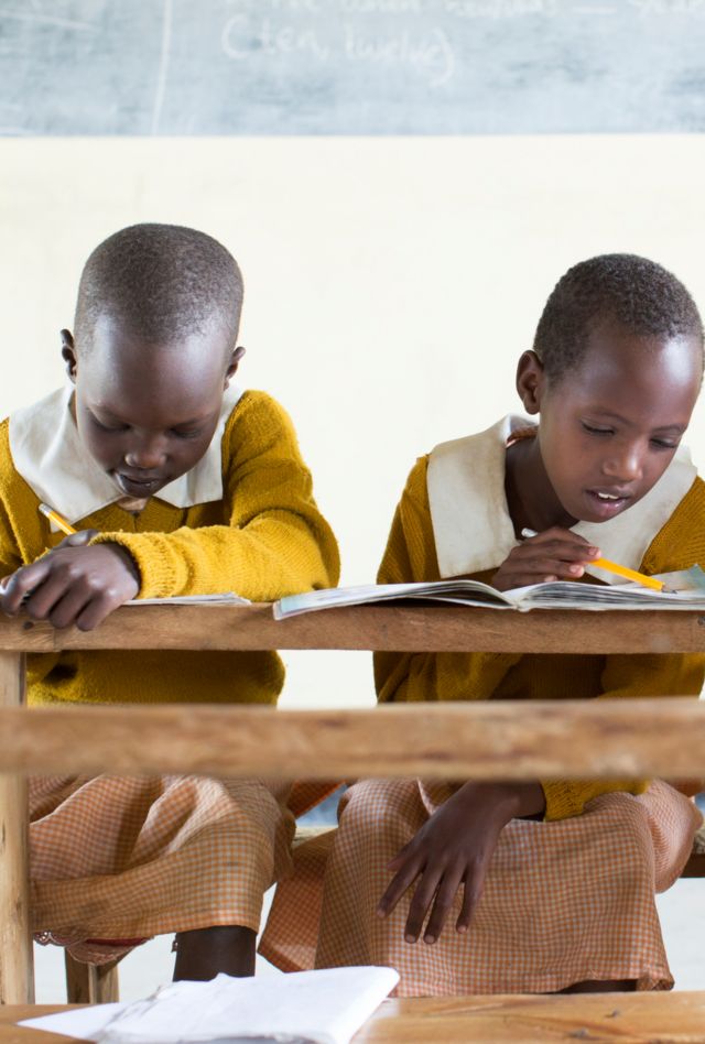 Three schoolgirls studying in class.