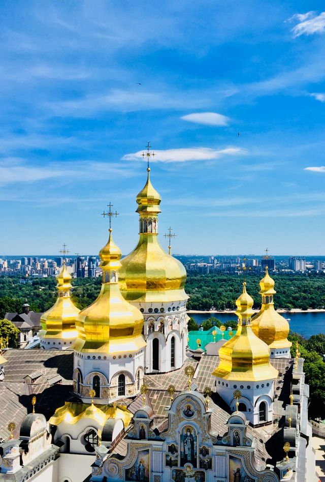 A view of the roof of an elaborate church with golden onion-shaped cuppolas