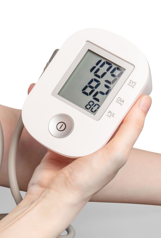 An arm bearing a blood pressure cuff