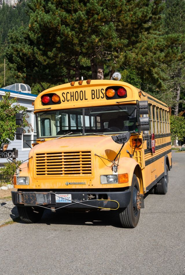 2GJM71R Index, WA, USA - September 08, 2021; An International manufactured school bus parked on the street outside the rural school in Index Washington