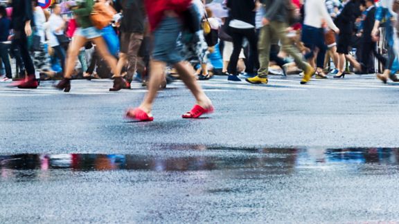 People, crossing Shibuya Scramble Intersection, Tokyo, Japan on a rainy day. 