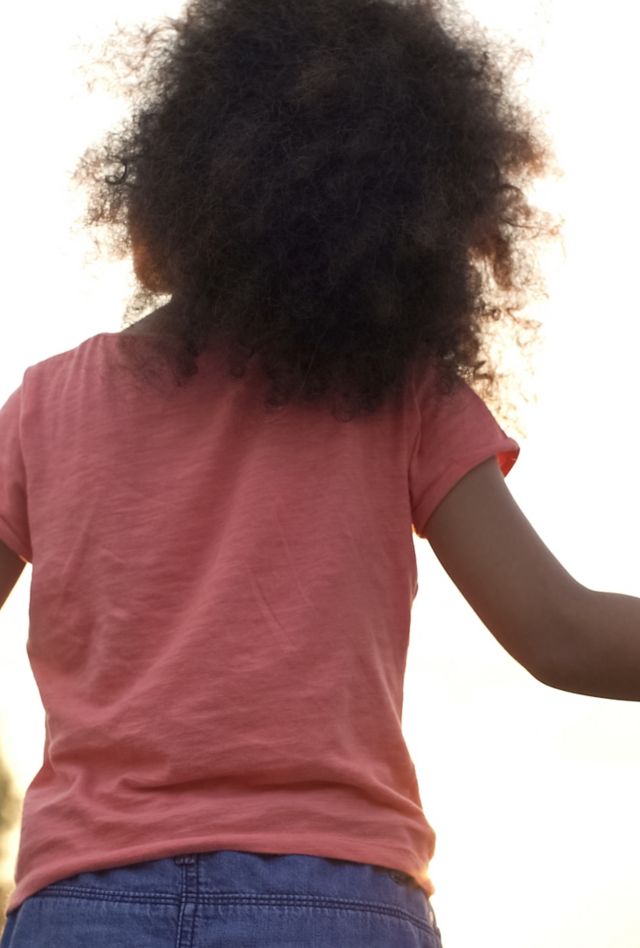 Perfect family holding hands, adopted child being supported by loving parents