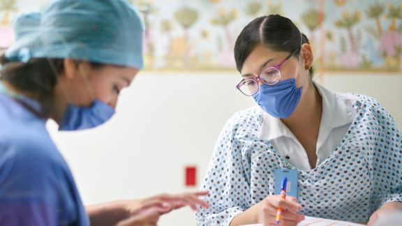 Doctor And Nurse Preparing Documents With A Tablet 