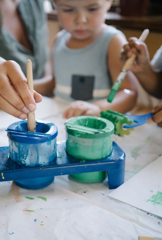 A mother does arts and crafts with her sons at home