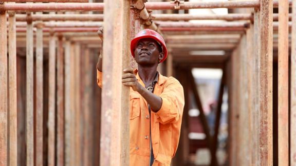 2CXTA7K A construction worker erects a scaffolding on a tunnel along the Nairobi-Thika highway project, under construction near Kenya's capital Nairobi, September 23, 2011. The road, which is being built by China Wuyi, Sinohydro and Shengeli Engineering Construction group, is funded by the Kenyan and Chinese government and the African Development Bank (AFDB). The project will cost 28 billion Kenyan shillings ($330million), according to the Chinese company. AfDB has cut the expected economic growth rate for Kenya in 2011 to 3.5-4.5 percent from an earlier forecast of 4.5-5 percent due to high inflation