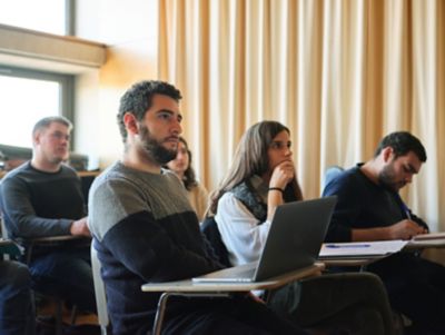 Group of students sitting in the classroom and paying attention to the lecture