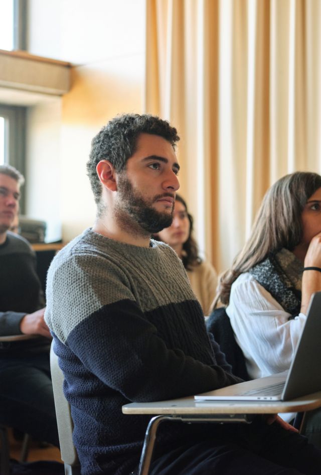 Group of students sitting in the classroom and paying attention to the lecture