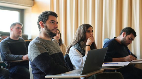 Group of students sitting in the classroom and paying attention to the lecture